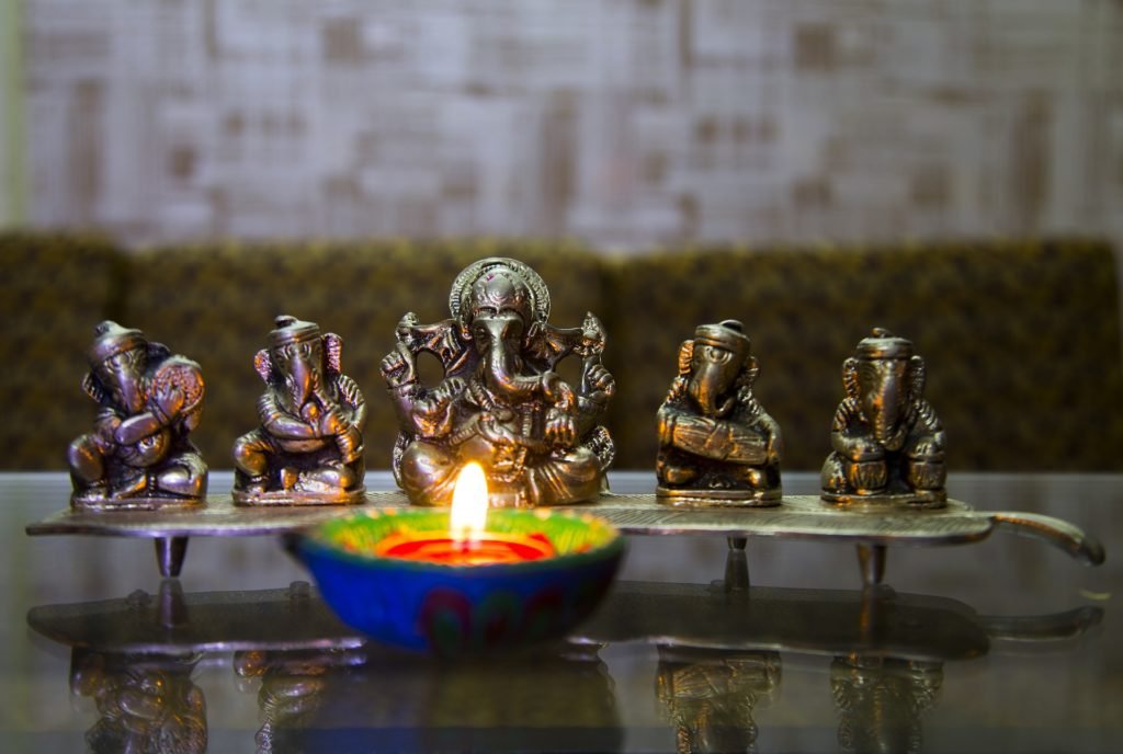 illuminated-lamp-beside-lord-ganesha-diwali-pooja