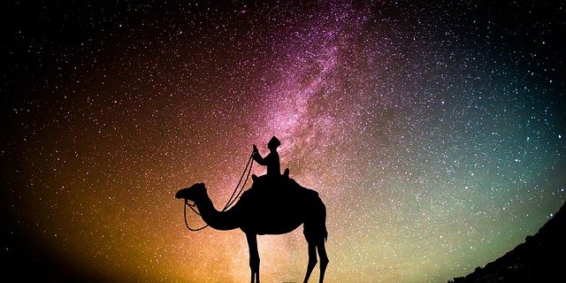camel rider on the desert at night arabic background